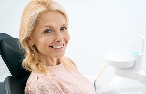 Happy senior woman in dental treatment chair