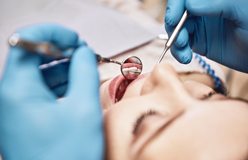 Dentist examining a patient’s teeth before surgery