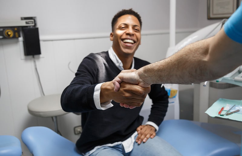 Invisalign patient in Boston smiling with their dentist