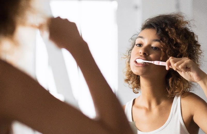 Invisalign patient in Boston brushing their teeth