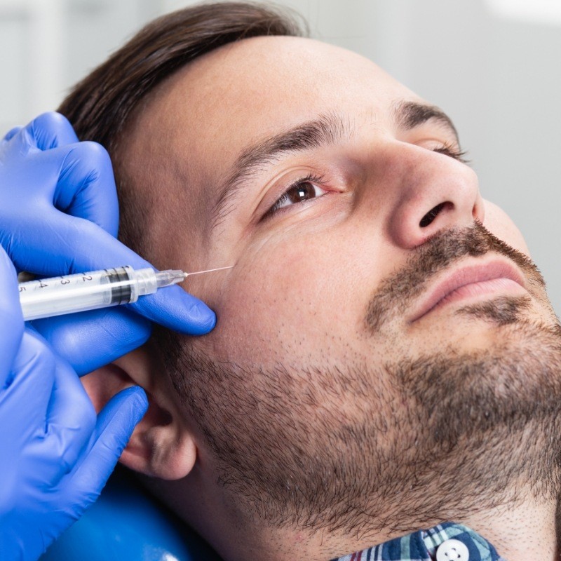 Bearded man receiving a Botox injection