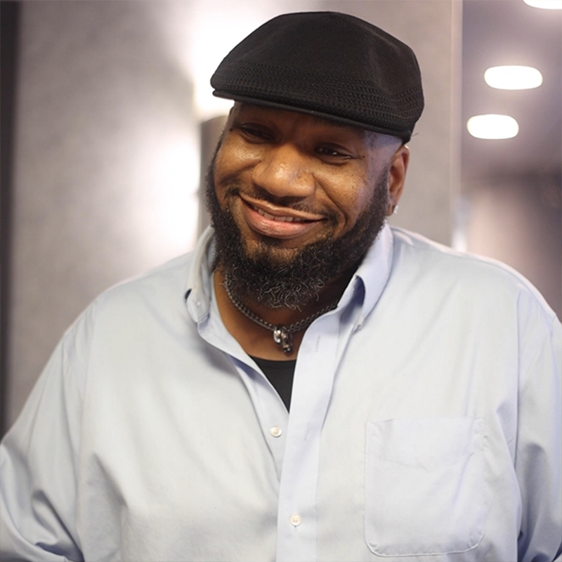 Bearded man standing outside smiling