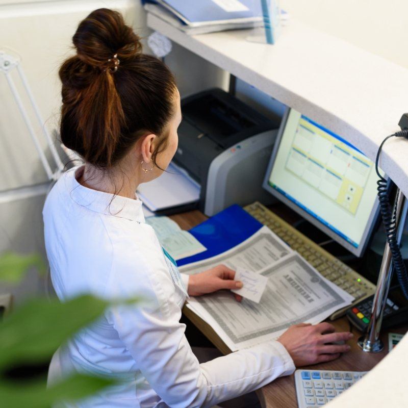 Dentist sitting at a computer