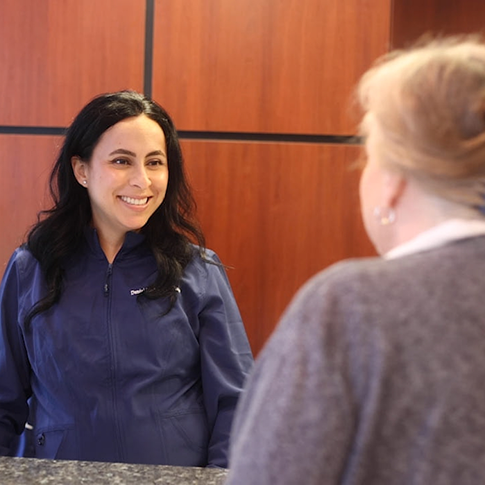 Dental team member smiling at patient