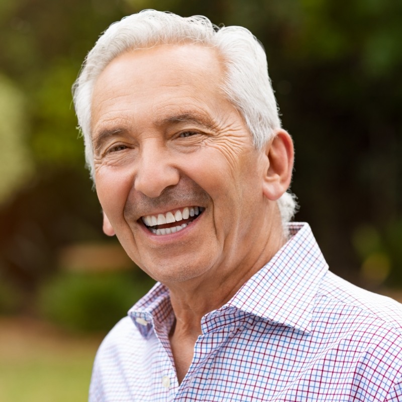 Man with white hair smiling