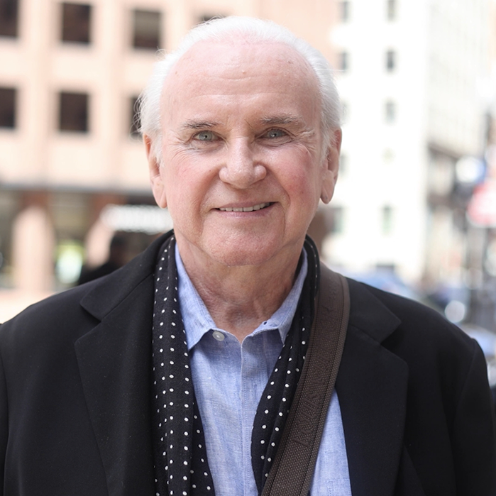 Older man standing outside and smiling