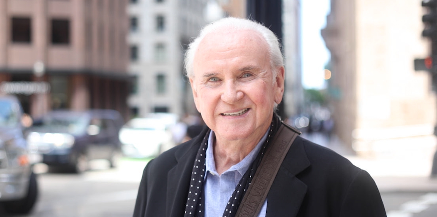 Smiling older man walking down the street