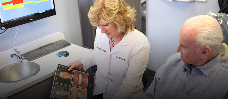 Dentist and patient looking at pictures of smiles