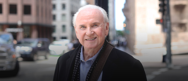 Smiling older man walking down the street