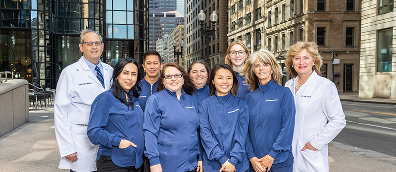 Dentists standing next to dental team