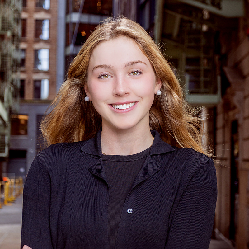 Blonde woman standing in street and smiling