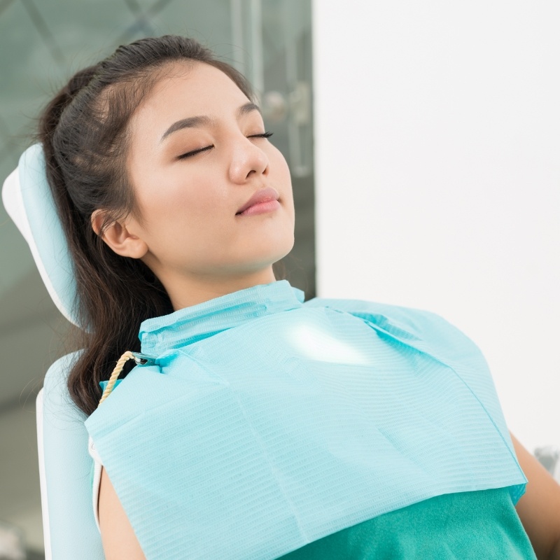 Woman relaxing in dental chair with sedation dentistry in Boston