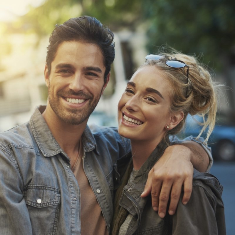 Man and woman standing and smiling