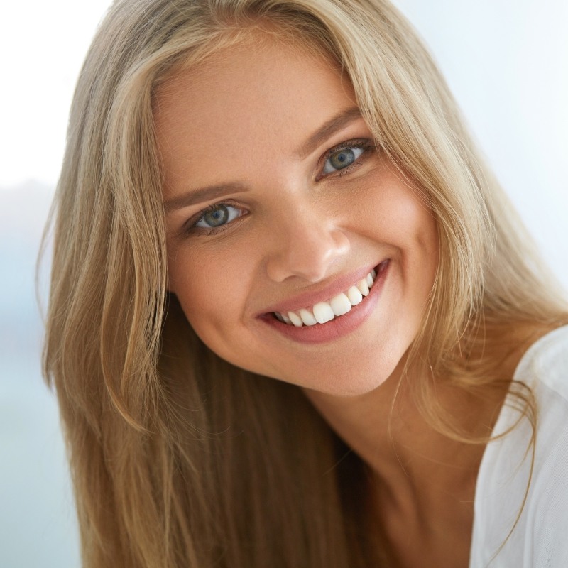 Woman in white shirt smiling