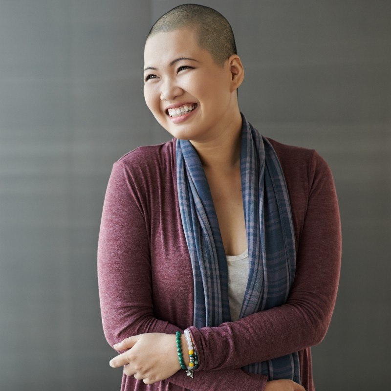 Woman in dark purple shirt smiling