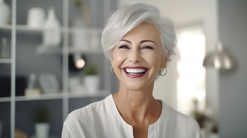 older patient smiling with their Invisalign aligner