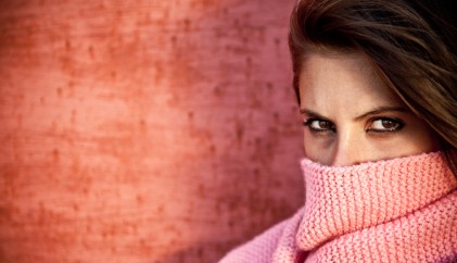 woman using scarf to cover mouth