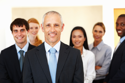 Portrait of confident multi racial business people smiling together at office