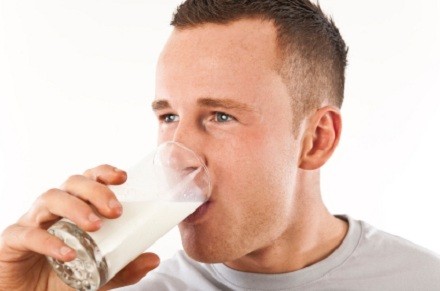 man drinking milk out of glass
