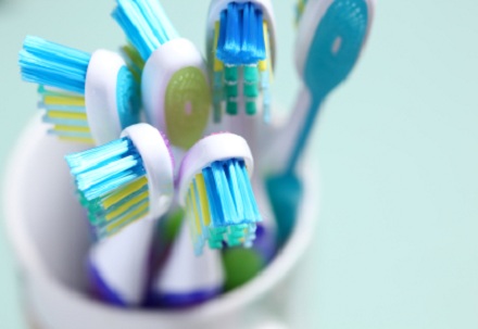 several toothbrushes in cup