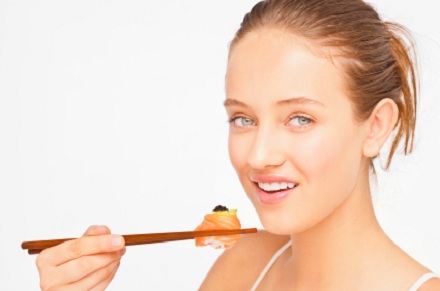 a young woman eating sushi